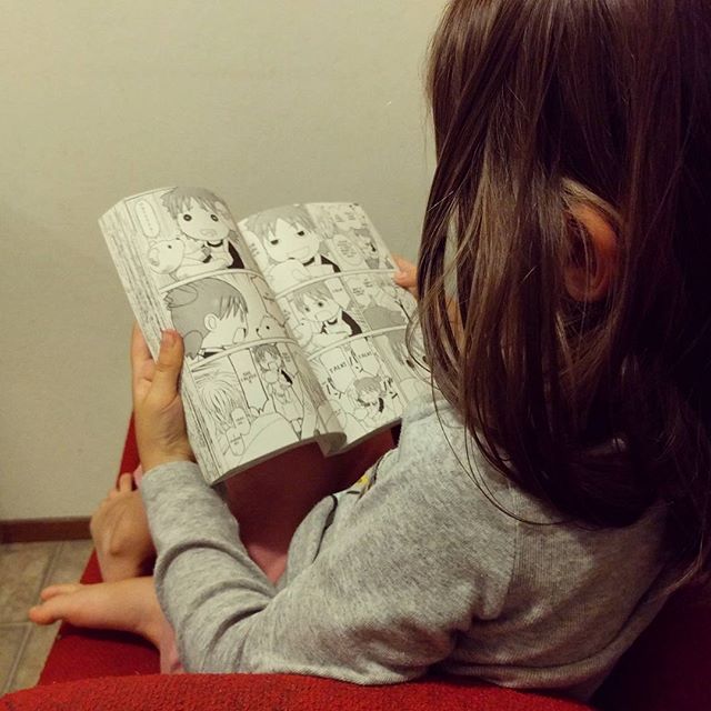 Reading Yotsuba, her favorite manga. maiki and Clover read them every night at bedtime.