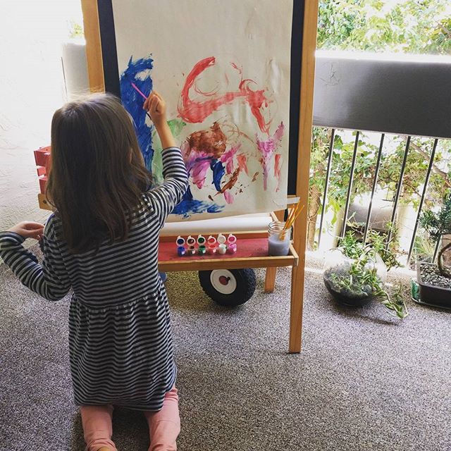 painting while humming to herself