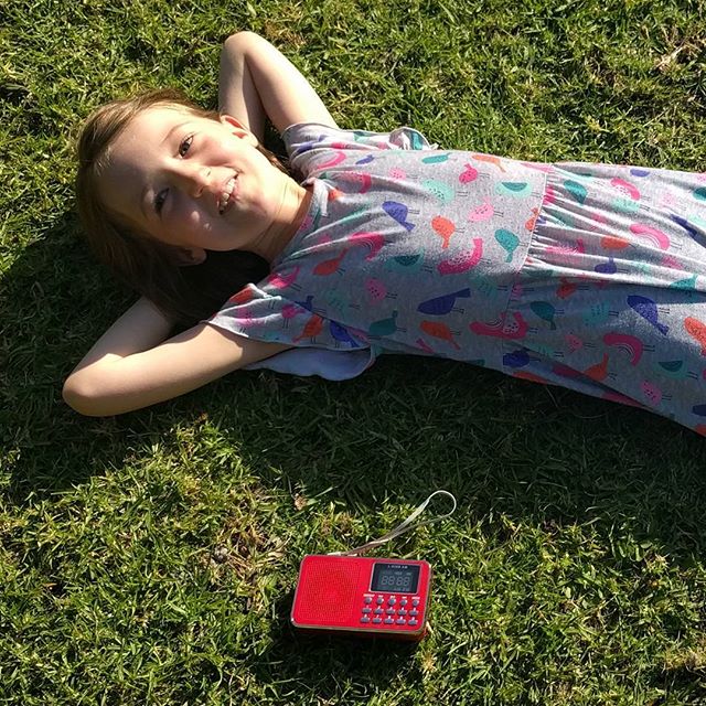 A girl and her red radio. Putting together her Kiki costume.
